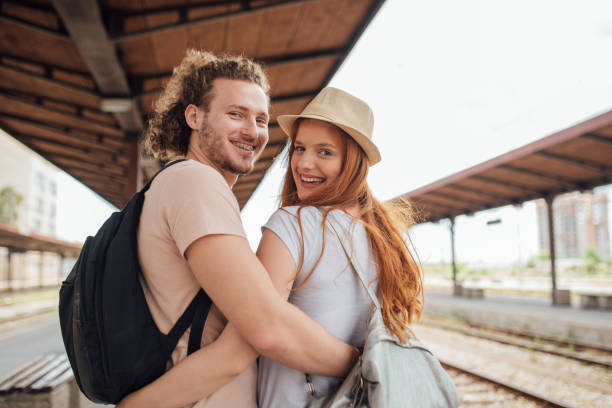 istock Young couple with backpacks on their backs hugging 995339388