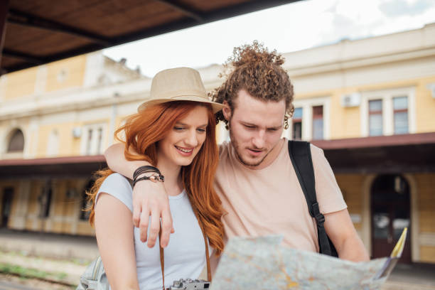 istock Young couple reading the map at the railway station 995343826