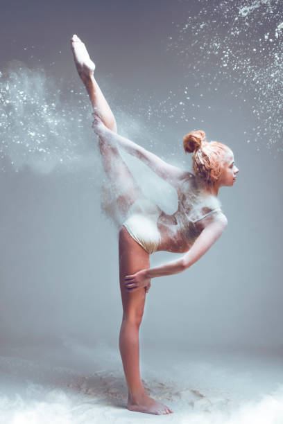 istock Redhead woman dancer in dust / fog 995354984