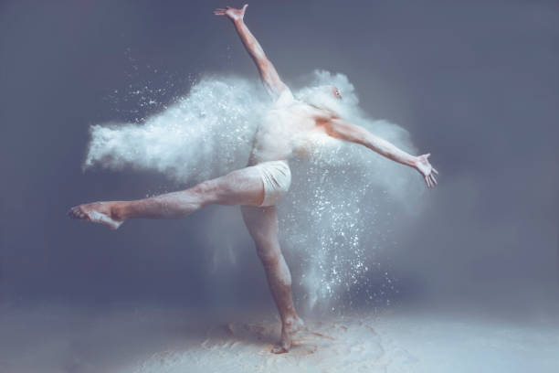 istock Muscle man dancer in dust / fog 995357206