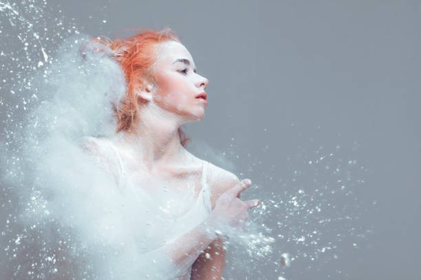 Redhead woman dancer in dust / fog Dancing in flour concept. Redhead woman dancer in dust / fog. Portrait of a girl dancer with ginger hair in flour on isolated background crazy makeup stock pictures, royalty-free photos & images