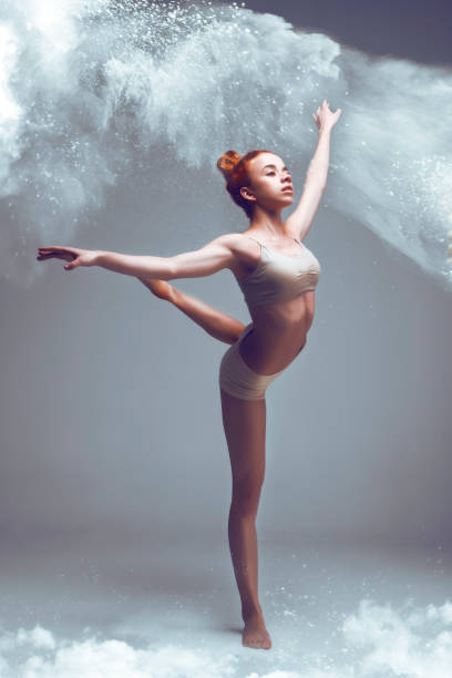 istock Redhead woman dancer in dust / fog 995357836