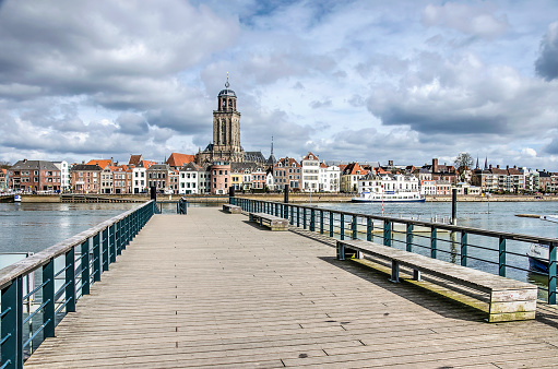 The new ferry pier in Deventer, The Netherlands, constructed on the location of the historic pontoon bridge, with the town's skyline in the background