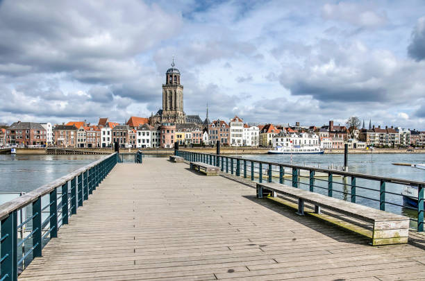 Deventer and the new ferry pier The new ferry pier in Deventer, The Netherlands, constructed on the location of the historic pontoon bridge, with the town's skyline in the background deventer photos stock pictures, royalty-free photos & images