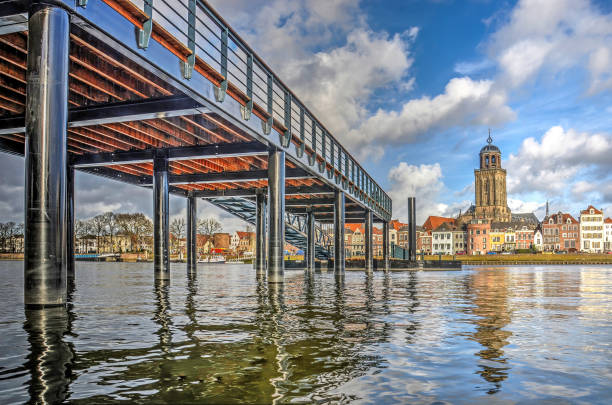 The return of the pontoon bridge Low view across the IJssel river towards the city of Deventer, The Netherlands and the new ferry pier, constructed on the location of the historic pontoon bridge deventer photos stock pictures, royalty-free photos & images
