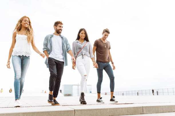 istock friends walking together in barceloneta 995378722