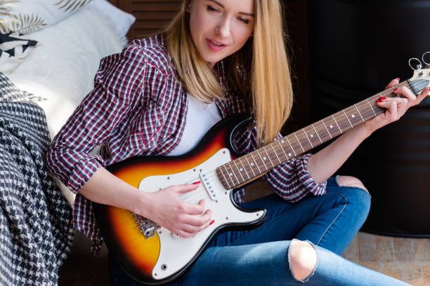 istock musical talent hobby woman playing guitar singing 995379396
