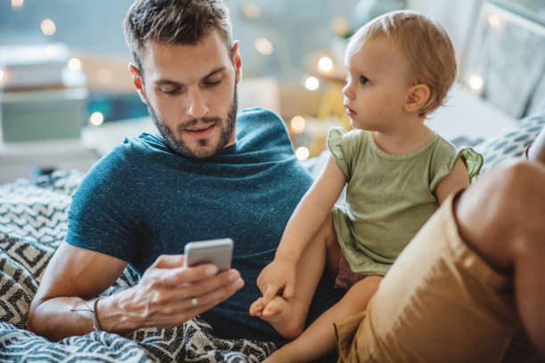 istock Father shows little daughter something on phone 995382172