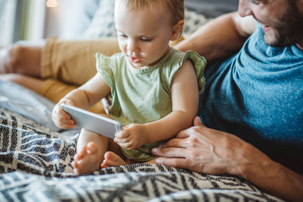 istock Father shows little daughter something on phone 995382238