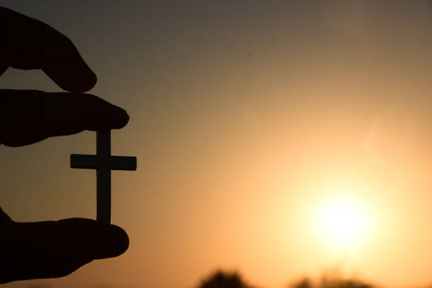 istock A human hand holds A Christian cross 995394412