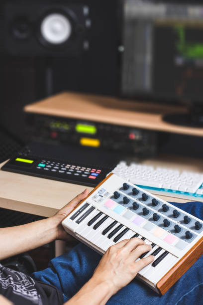 istock male producer hands playing keyboard for recording midi track on computer in home studio 995398374