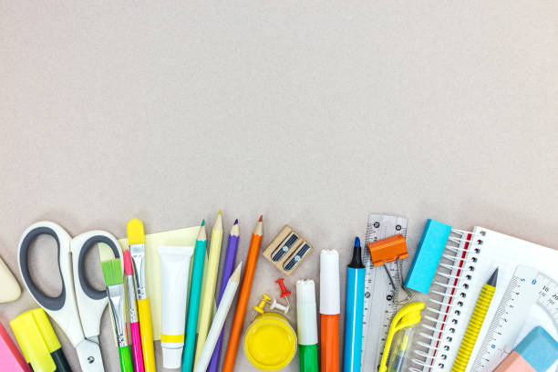 istock various school supplies and office stationary on grey background 995398634