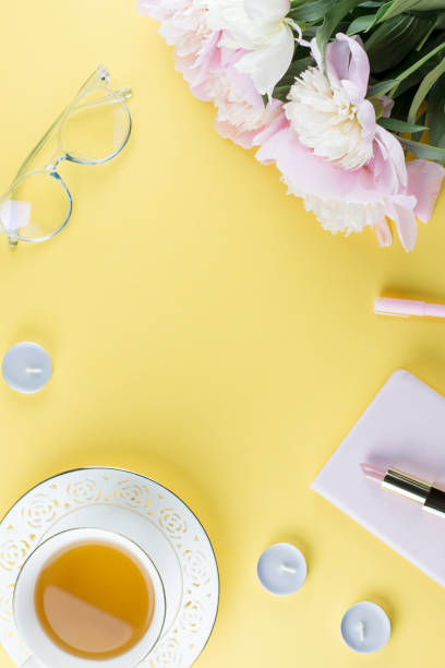istock Flat lay home office desk. Feminine workspace with diary, peony flowers, cosmetics, green tea. Fashion blogger concept. 995401816