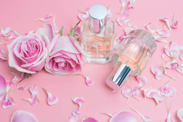 istock Beautiful perfume bottles on pink background 995403076