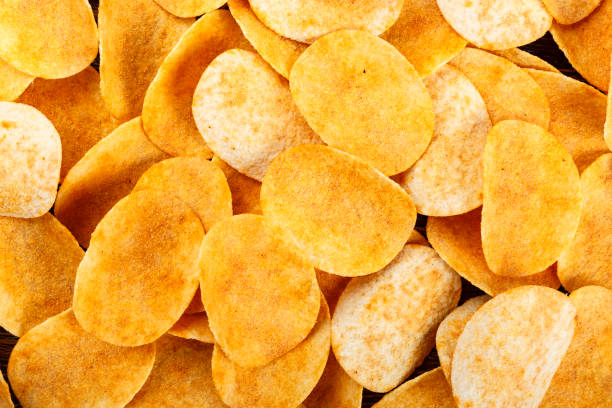 istock a lot of potato chips as a background. 995408560