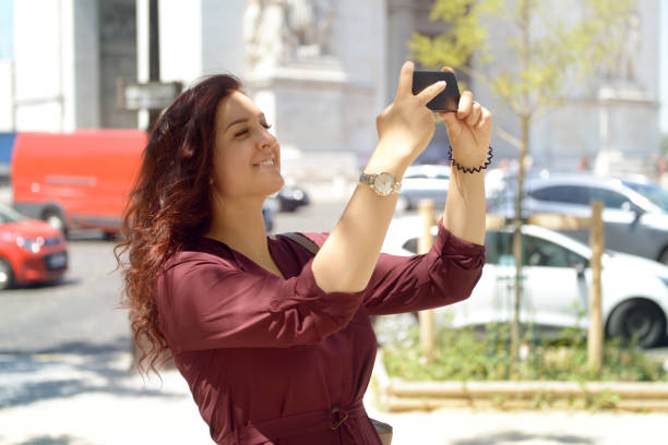istock young woman walks in Paris (with smartphone) 995409836