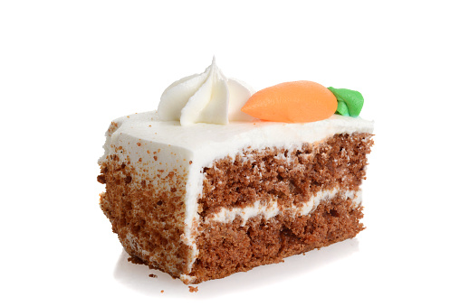 slice of carrot cake with frosting on a white background