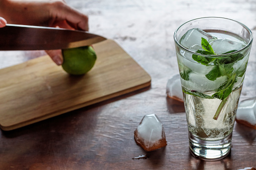 mojito, kaipirinha, vodka. preparing an alcoholic or non-alcoholic cocktail. hands, bartender, bar, restaurant mint lime lemon alcoholic non-alcoholic