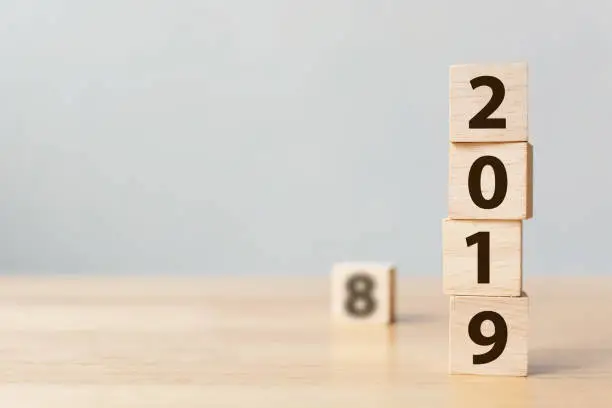 New year 2018 change to 2019 concept. Wooden block cube with number on table