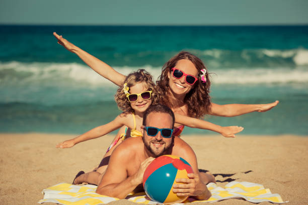 istock Happy family having fun on the beach 995421094