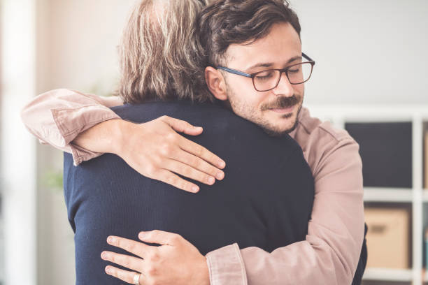 istock Son hugs his own father 995423082