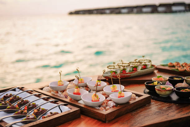 Elegant selection of gourmet tapas by the sea in the sunset