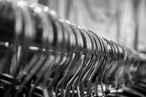 istock Close-Up Of Coathangers Hanging On Rod 995444228