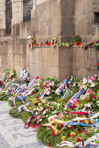 PRAGUE, CZECH REPUBLIC - June 19, 2018:   Flowers laid outside The Church of Sts Cyril & Methodius in memorial to the seven Czech paratroopers who were involved in Operation Anthropoid, the code name for the assassination of Reichsprotektor Reinhard Heydrich in 1942.  The paratroopers hid in the church's crypt for three weeks after the killing, until their hiding place was betrayed by the Czech traitor Karel urda. The Germans besieged the church, first attempting to smoke the paratroopers out and then flooding the crypt with fire hoses. Three paratroopers were killed in the ensuing fight; the other four took their own lives rather than surrender to the Germans.
