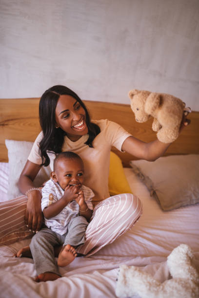 istock Mother and little son having fun playing together at home 995463910