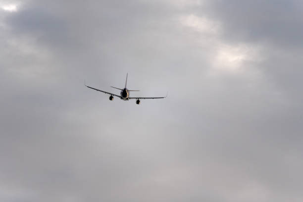 istock The plane is flying in the sky with gray clouds. 995469090