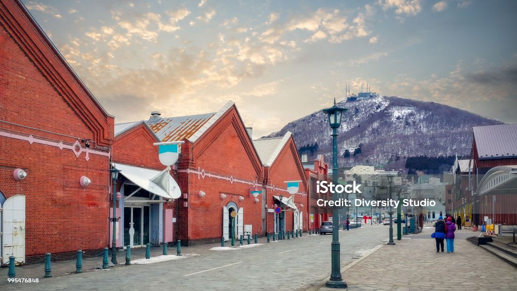 Cityscape of the historic red brick warehouses and Mount Hakodate Ropeway at sunset on Hakodate Mountain at Hakodate near Sapporo, Hokkaido Japan at winter Hakodate Stock Photo