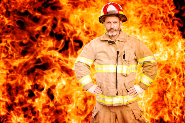 istock fireman standing in front of wall of fire 995485254