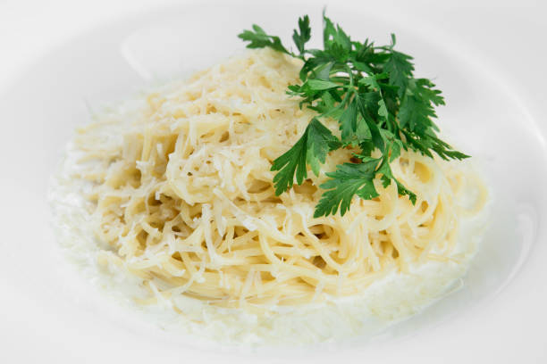 istock Pasta with parmesan on white plate on a black wooden background. 995493526
