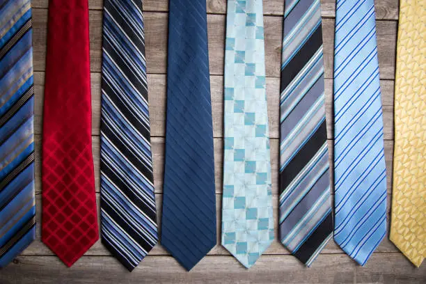 Multiple neckties on a wooden background