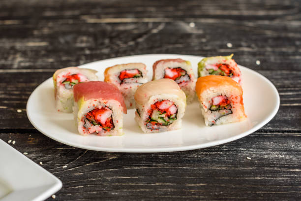 istock Fresh and tasty sushi on dark background 995514114