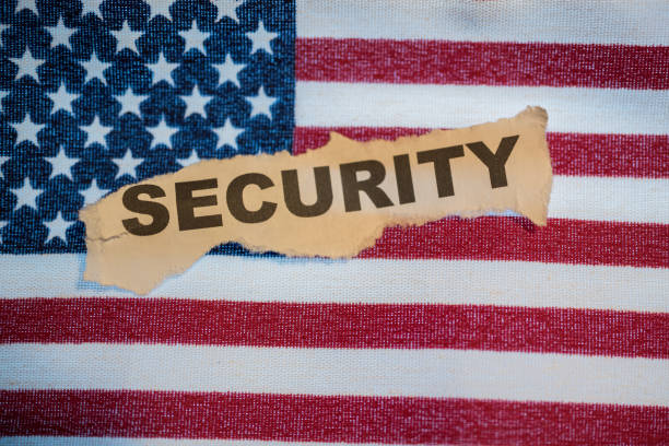 istock The word security in torn paper laying on the American Flag 995514136