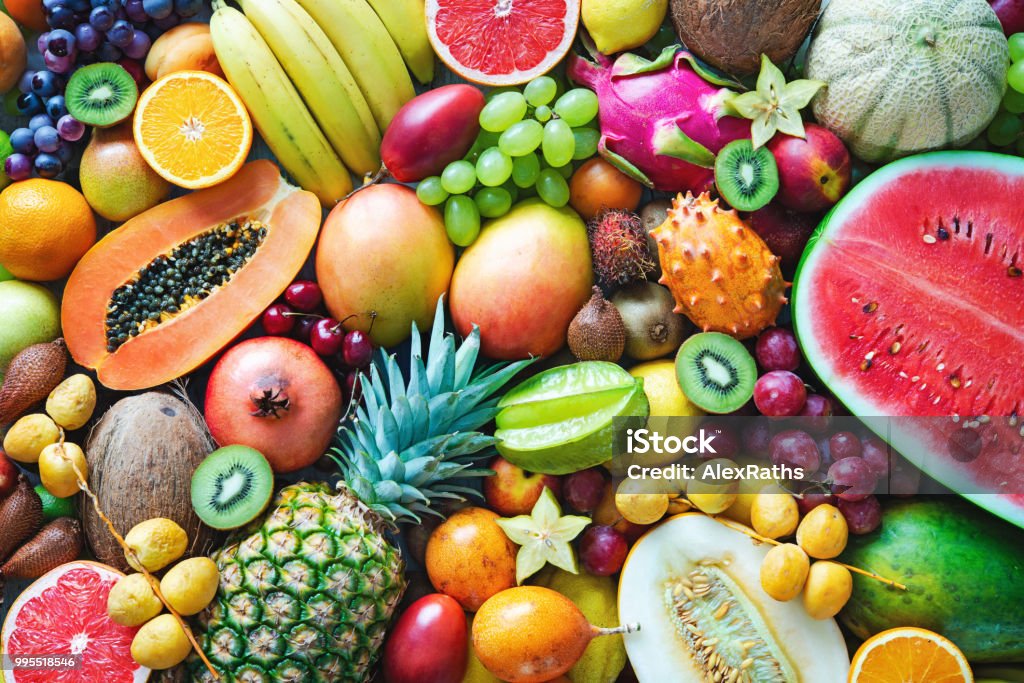 Assortment of colorful ripe tropical fruits. Top view Food background. Assortment of colorful ripe tropical fruits. Top view Fruit Stock Photo