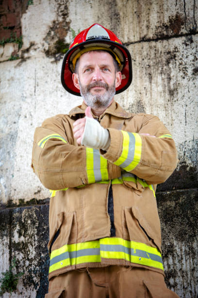 istock handsome fireman in uniform with thumbs up 995528908