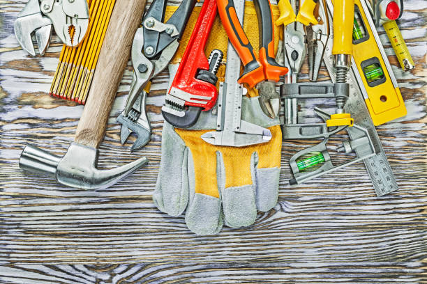 Set of construction tooling on wooden board.
