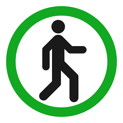 Pedestrian silhouette in green circle. Vector icon.