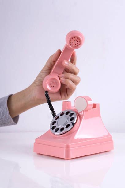 istock Female hand holding Pink Retro Phone 995538456