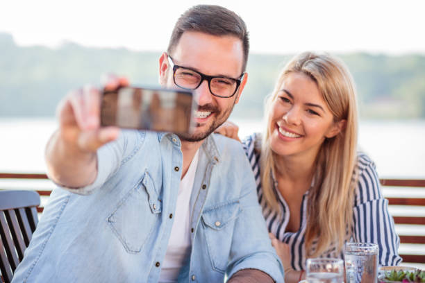 istock Happy young couple taking a selfie in a cafe 995539222