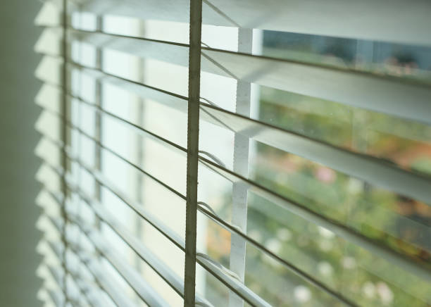 istock Close-up of a window blinds at white house 995543462