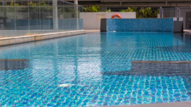 istock Beautiful swimming pool with Pool stair on sunny day 995556418