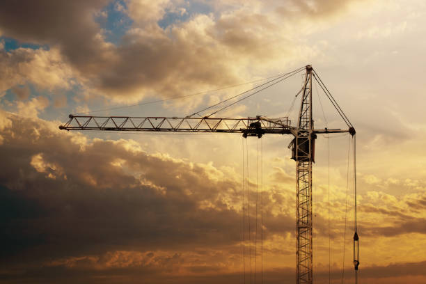 istock Tower crane on a construction site at sunrise 995559580