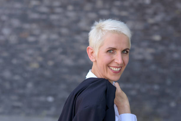 istock Happy woman is wearing her jacket over her shoulder 995566678