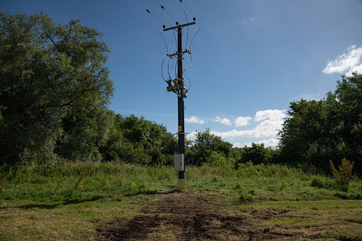 Wooden Electric Pole With Power Lines going into the distance