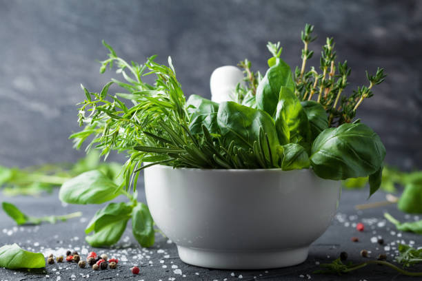 istock Fresh herbs and spices for traditional italian cuisine. Rosemary, basil, thyme, tarragon, pepper and salt. 995574708