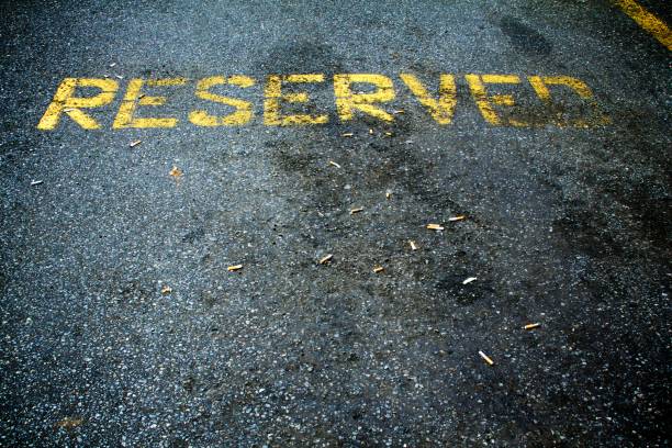 istock Discarded cigarette butts in a reserved parking space 995602606