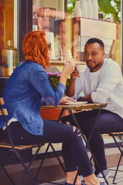 istock Couple drinks coffee in a cafe. 995603562